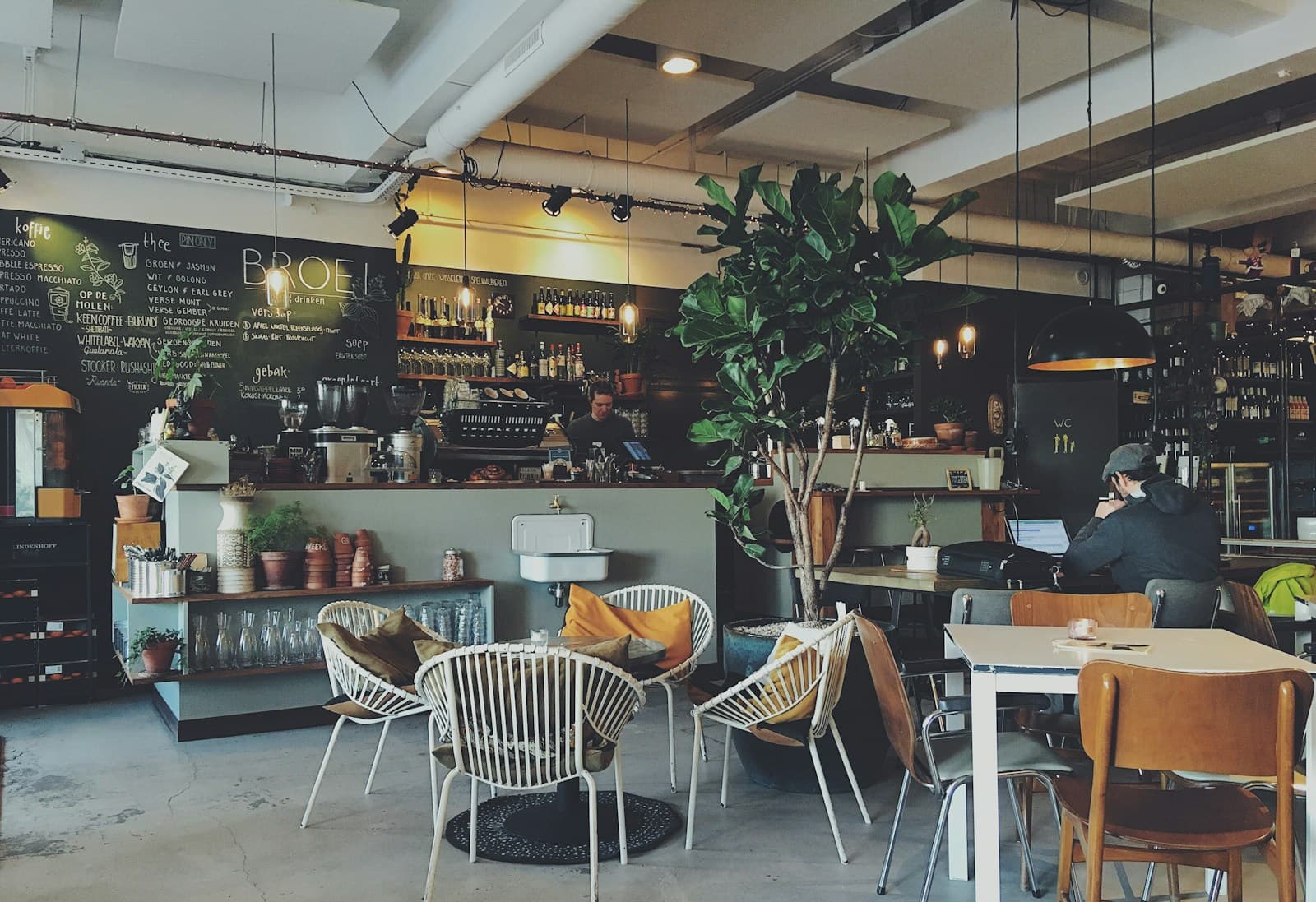 A diner orders from a phone at a café table